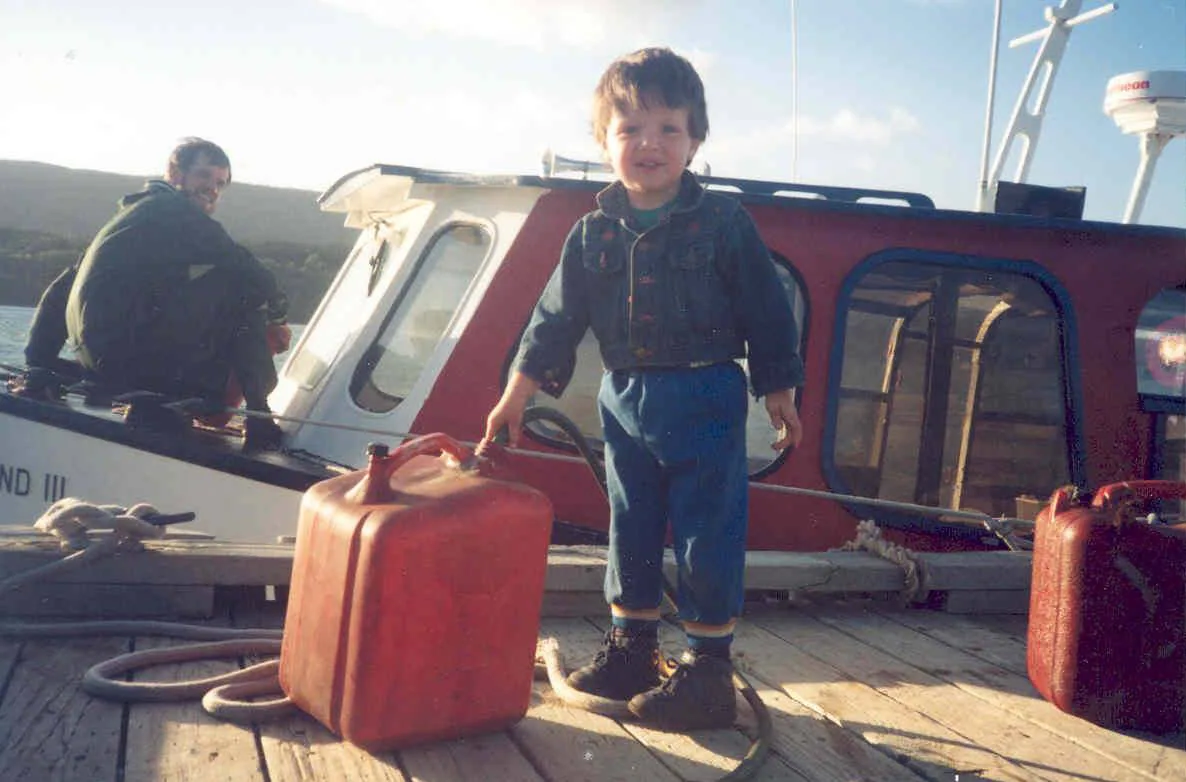 Future Captain Ian helping Captain Vince fuel up the Eastwind III in 1995