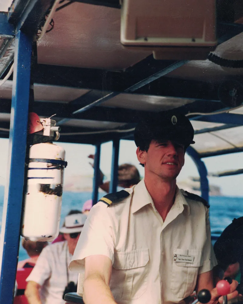 Captain Vince sitting at the helm of the Eastwind III in 1991