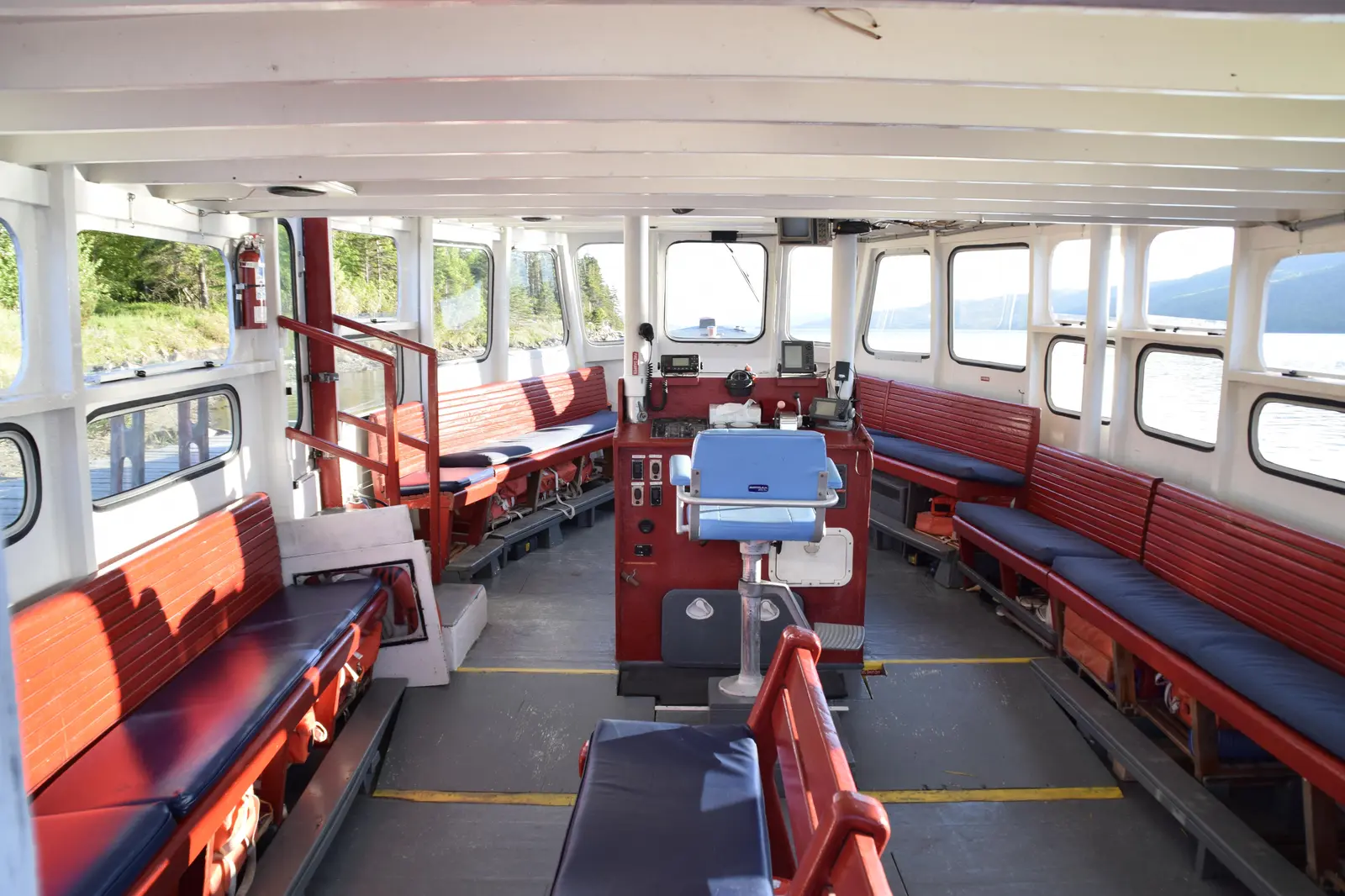 Inside the Puffin Express tour boat, showing removable windows and open seating